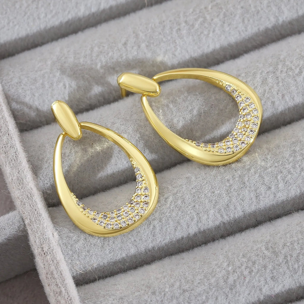 Yellow gold geometric drop earrings with oval shape measuring 2.6 by 1.7 centimetres