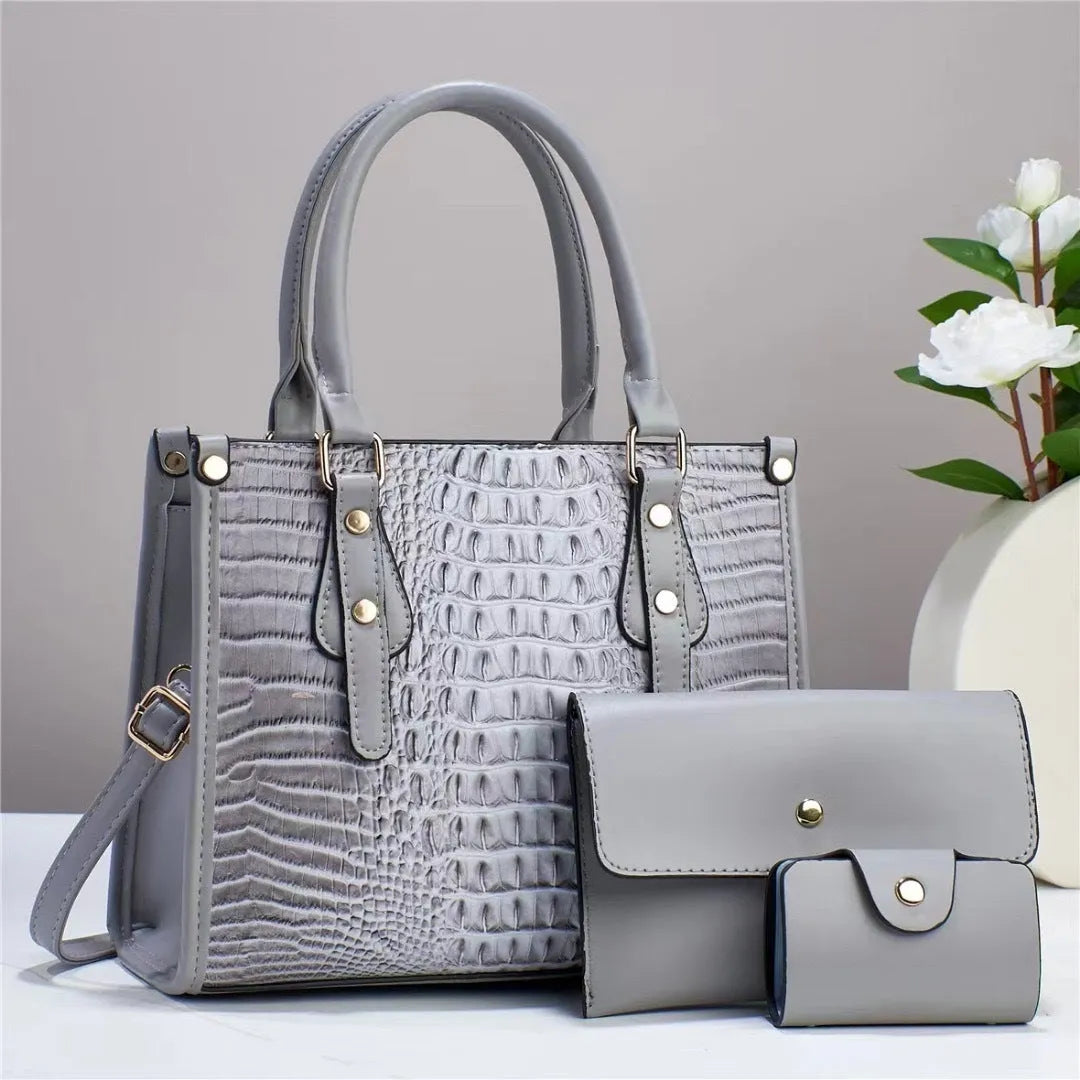 PU leather three-piece bag set showing bucket crossbody bag, wallet and card holder with contrast trim in burgundy colour