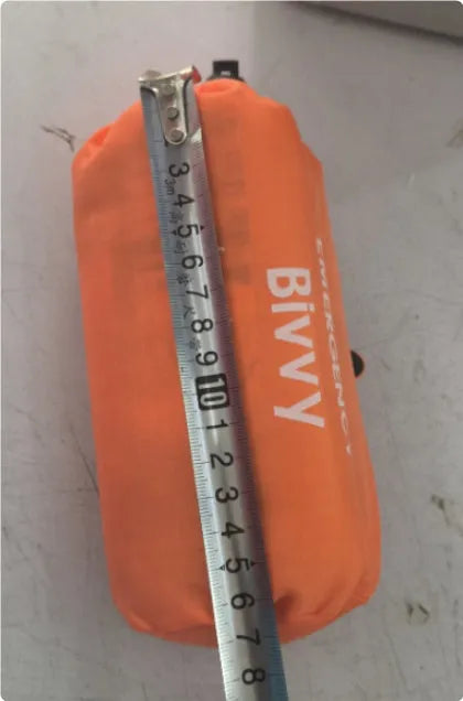 Orange emergency tent kit with sleeping bag, raincoat and whistle for disaster relief