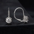 Sterling silver flower bud ear clip with white gold plating and a central moissanite stone.