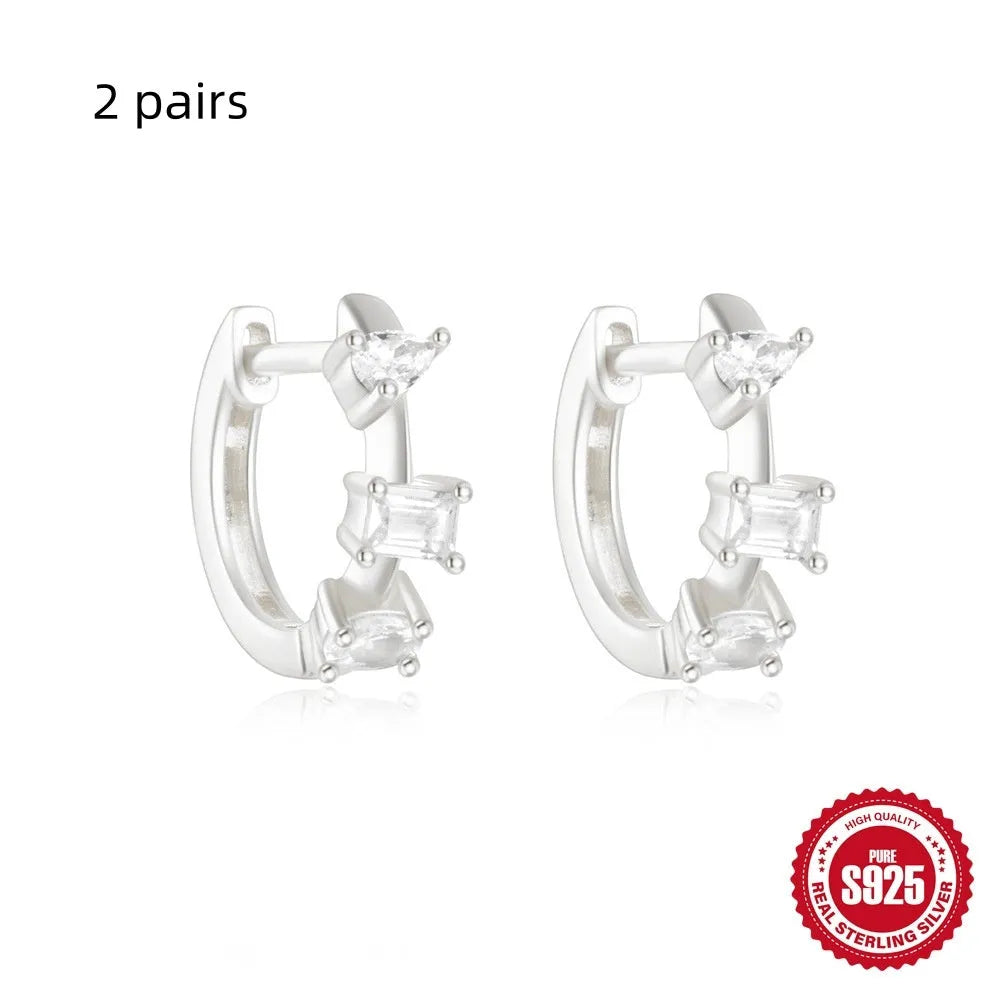 Sterling silver geometric stud earrings with round diamond accents in gold and silver electroplated finishes