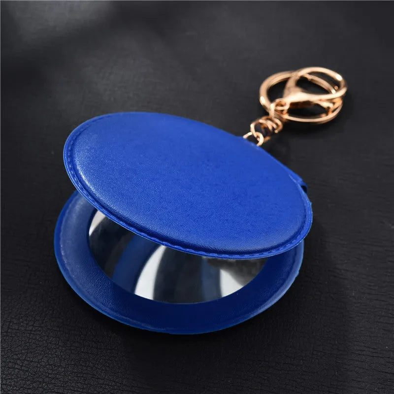 Compact round ladies leather makeup mirror with 8cm diameter glass surface and golden buckle