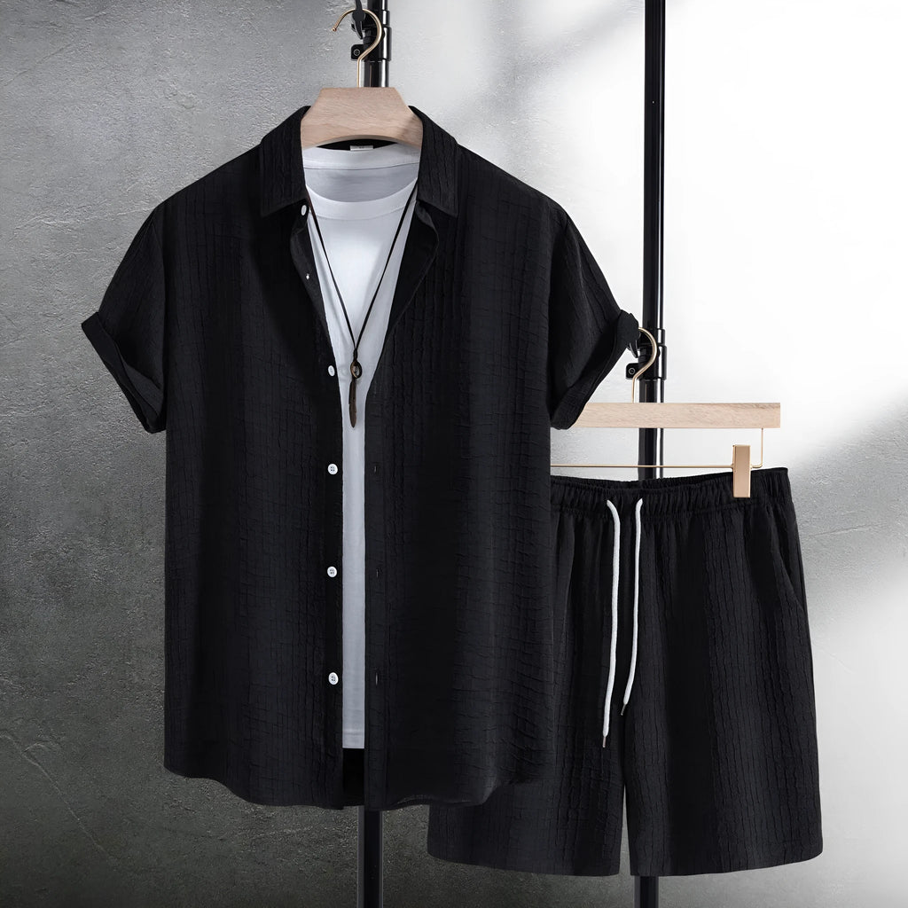 Men's white jacquard cotton blend short sleeve shirt and matching shorts laid flat.