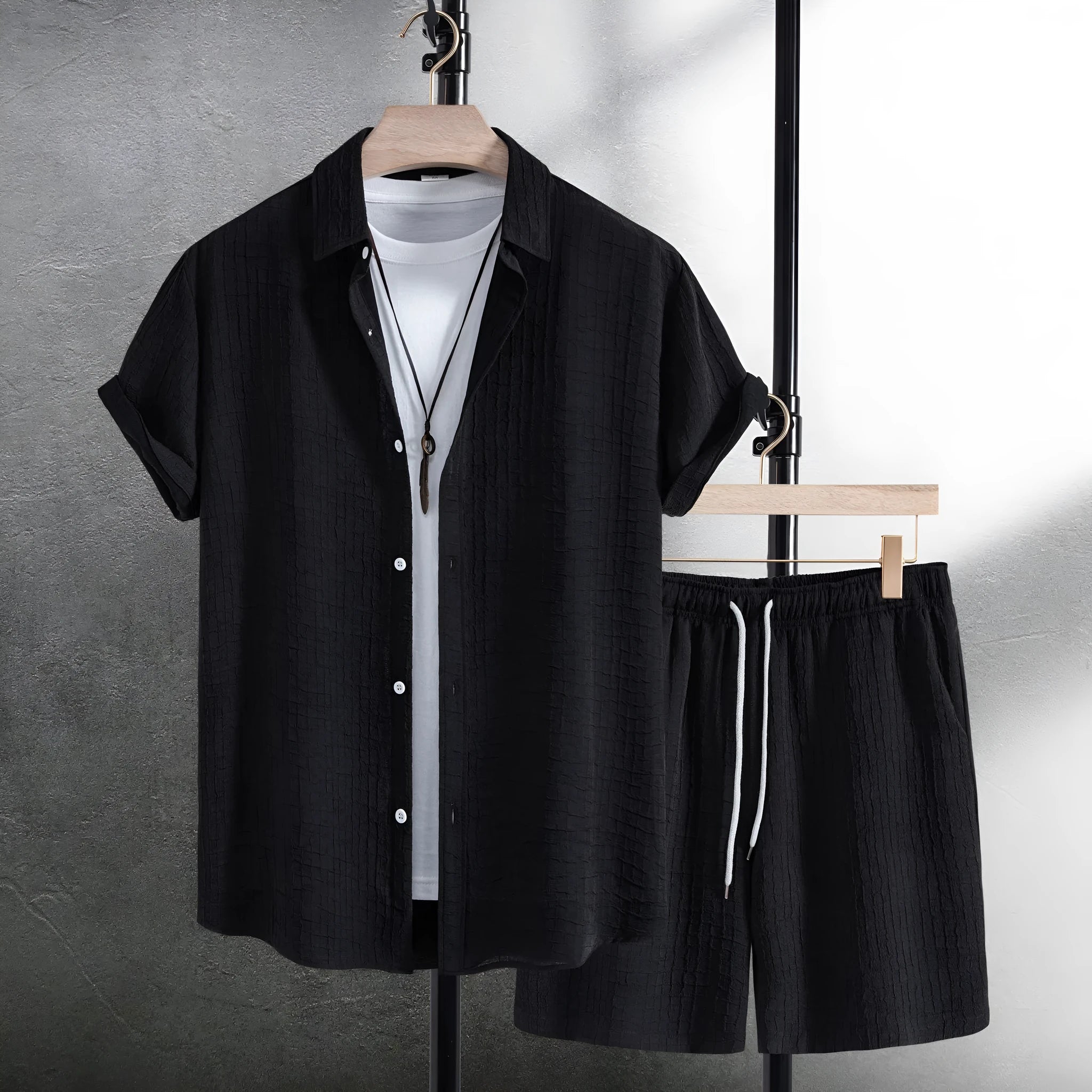 Men's white jacquard cotton blend short sleeve shirt and matching shorts laid flat.