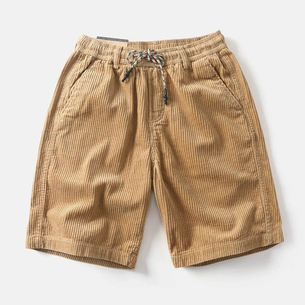 Men's khaki retro-style cargo shorts with a straight leg on a summer streetwear background.