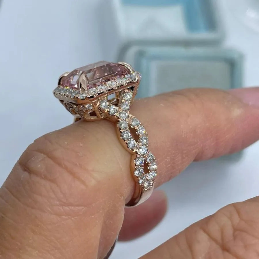 Rose gold electroplated alloy ring with geometric shape on white background