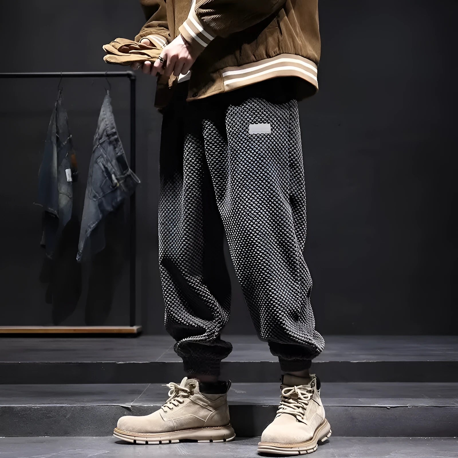 Men's grey ankle-tied straight-leg sweatpants laid flat, showing the tapered cut and tie detail.