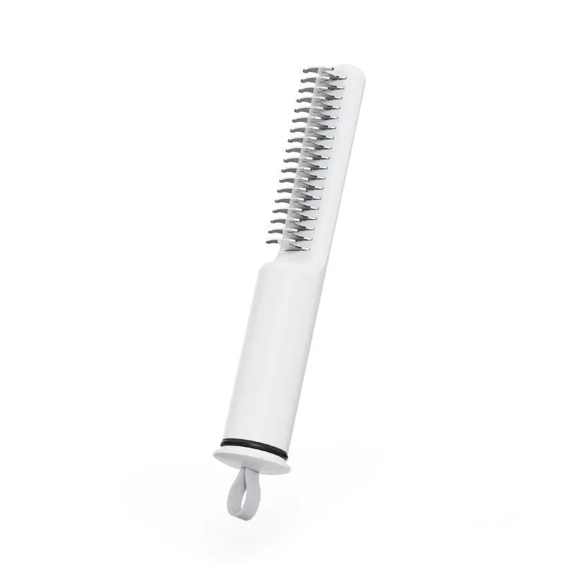 Pink and white pet dematting combs with stainless steel teeth on a wooden surface