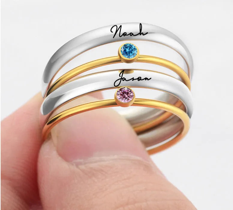 Close-up of a geometric titanium steel ring with December birthstone and engraved pattern, shown in one of three colour options.