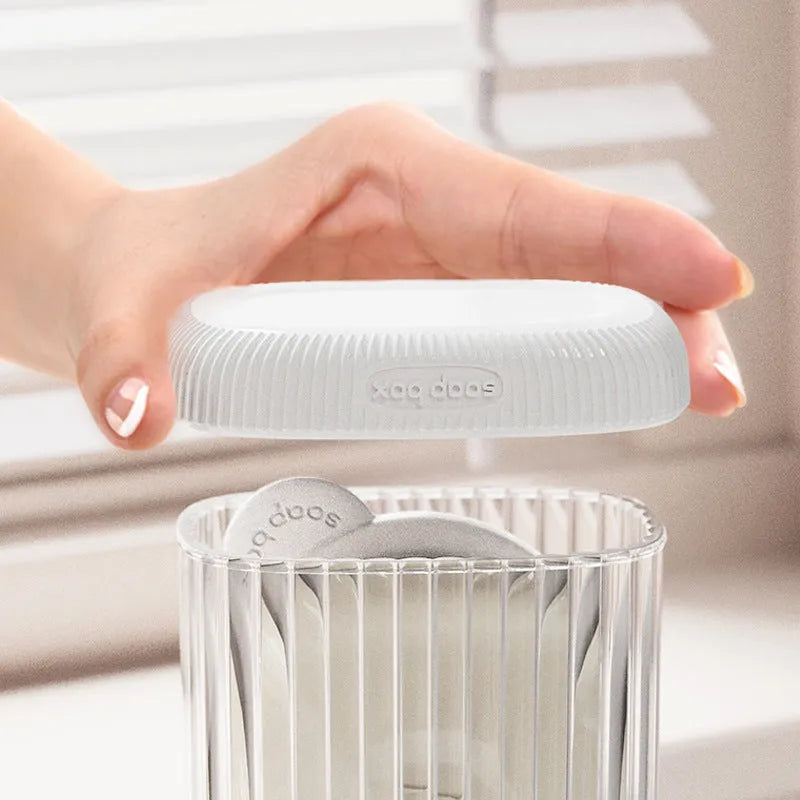 Compact PET travel soap dish in cream white, with a bar of soap on top