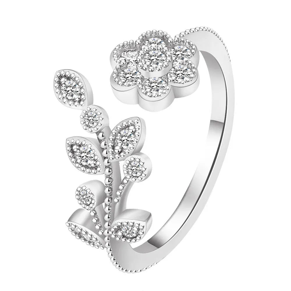 Copper open-ring with diamond-treated floral pattern and leaf details in gold colour