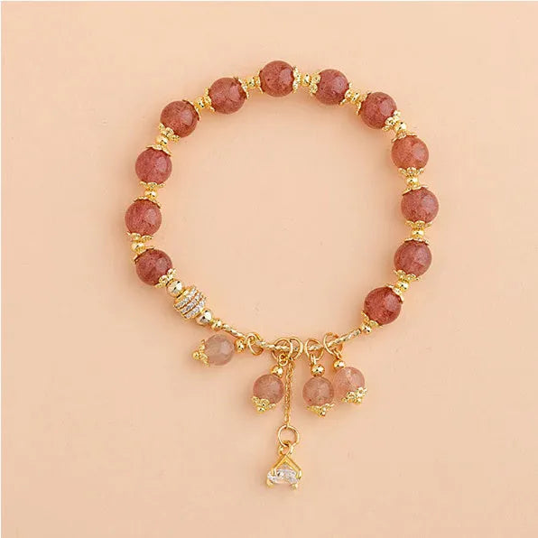 Women's pink crystal bracelet with heart-shaped design and pearl accents in strawberry quartz colour
