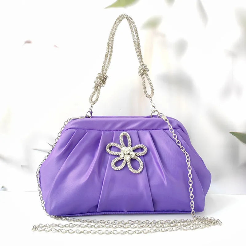 Soft lavender purple women's crossbody bag with chain details and a structured shell shape.