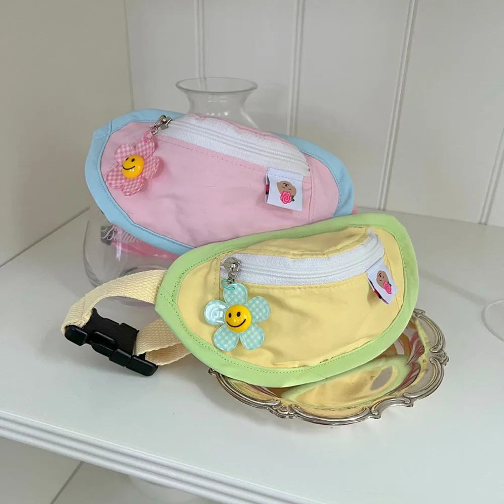 Pink and yellow messenger bag-style pet backpack carrier for small dogs and cats showing adjustable straps