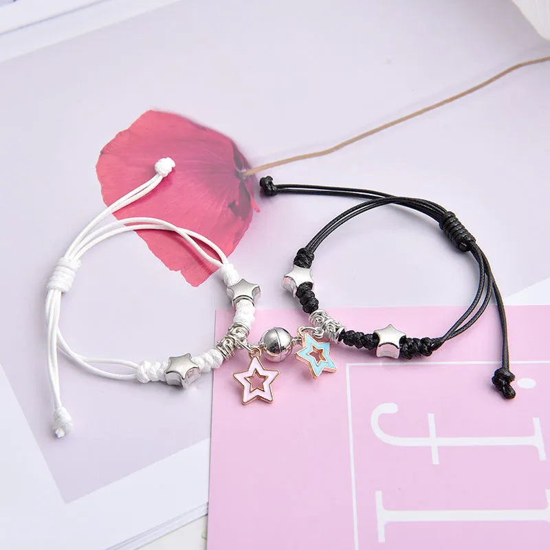 Magnetic clasp couple bracelets with alloy construction and symbolic designs including crown and love lock motifs.