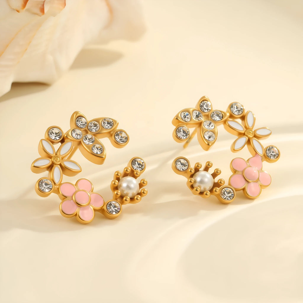 Close-up of colourful oil finish flower-shaped stud earrings with petal details on a stainless steel post.