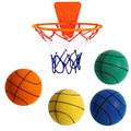 Assortment of bright coloured silent foam basketballs with a basketball frame on a neutral background