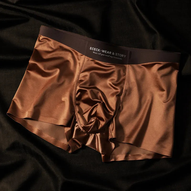 Men's solid colour ice silk seamless underwear laid flat, showing its knit construction.