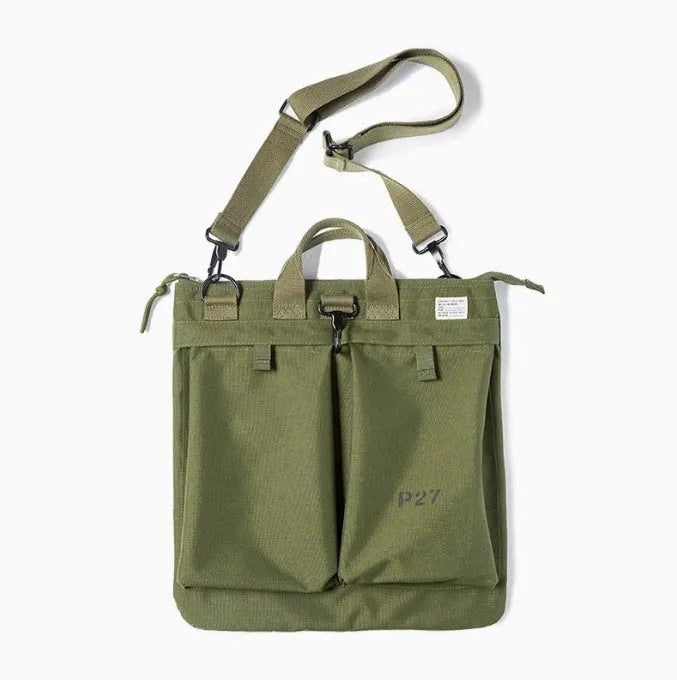 Medium canvas crossbody messenger bag in military green showing laptop compartment and shoulder strap