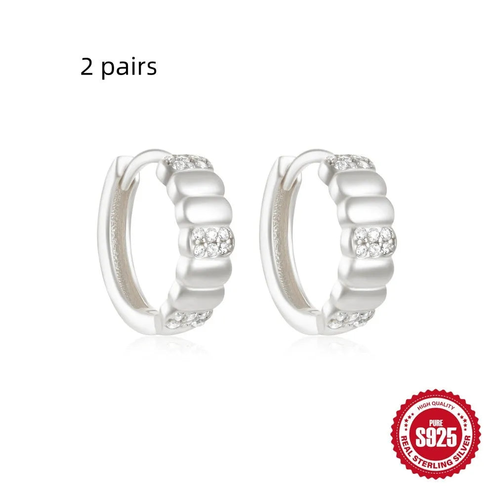 Sterling silver geometric stud earrings with round diamond accents in gold and silver electroplated finishes