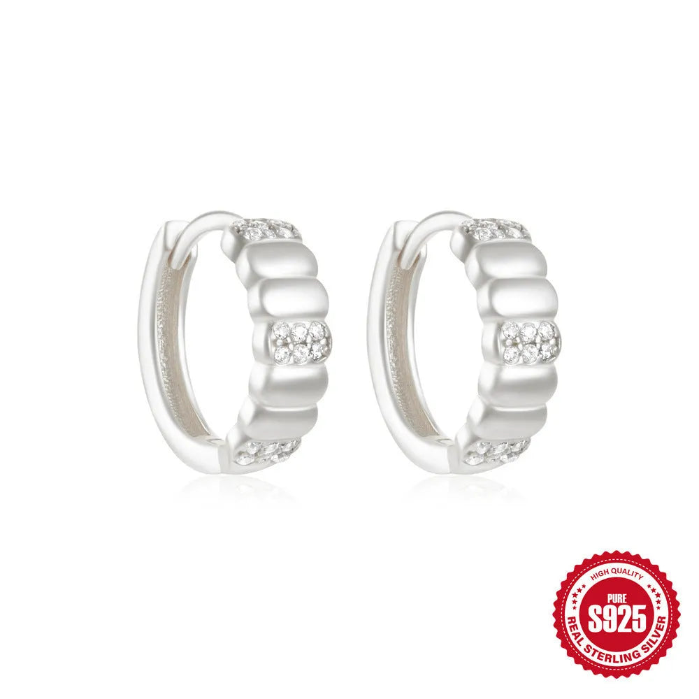 Sterling silver geometric stud earrings with round diamond accents in gold and silver electroplated finishes