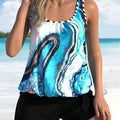 Blue floral patterned women's two-piece swimsuit with bikini top and shorts on a hanger.