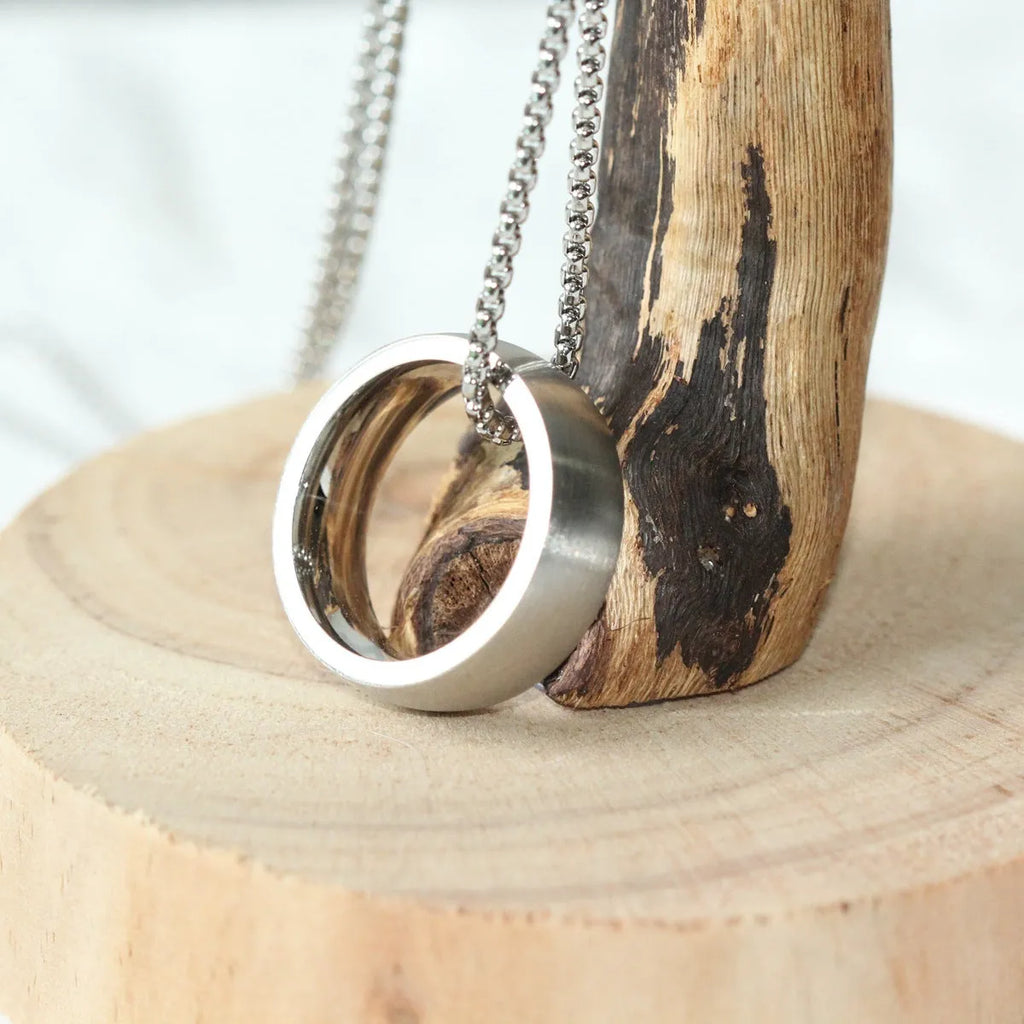Men's silver pearl chain circle pendant necklace with stainless steel chain and titanium steel pendant on neutral background