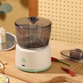 Mini electric meat grinder with transparent cup and stainless steel blade in light green or white
