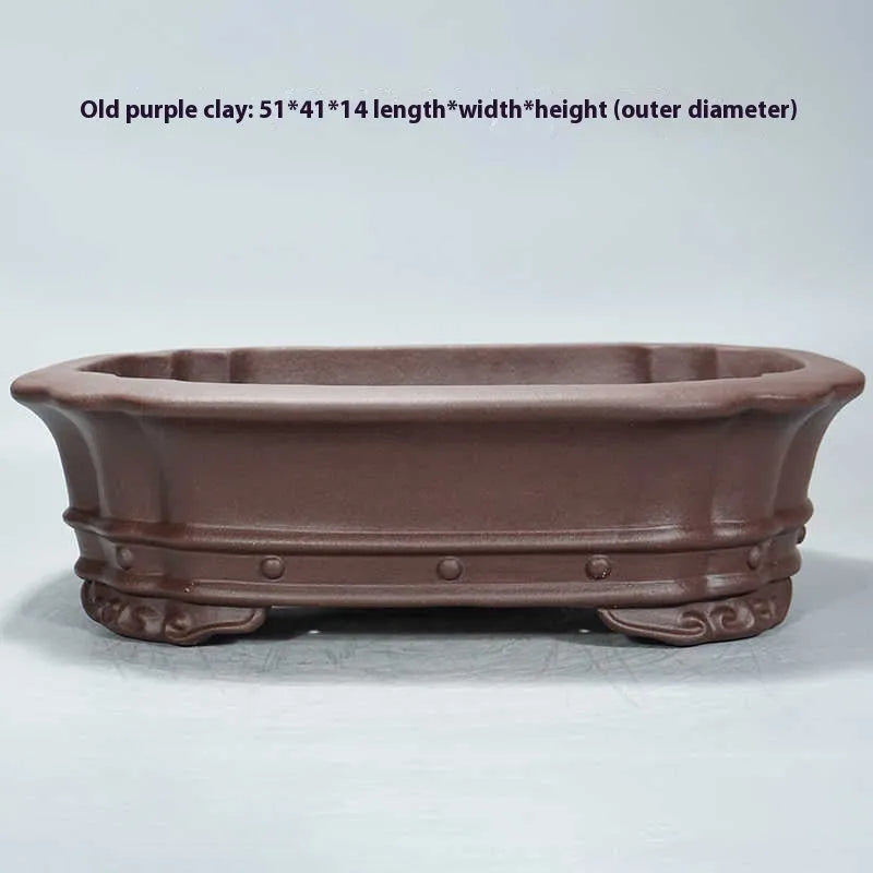 Handmade purple clay rectangular flower pot with antique finish on desktop
