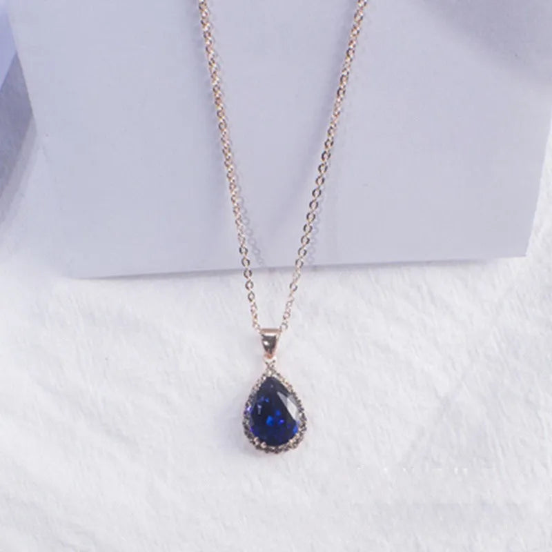 Rose gold geometric drop necklace with rhinestone details in pink colour option