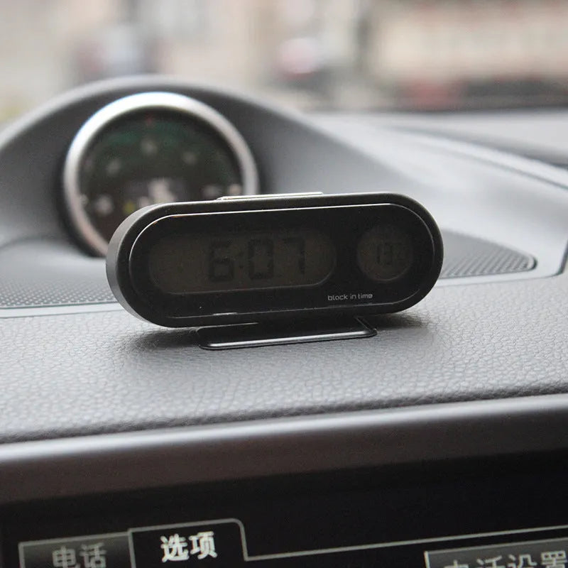 Black car dashboard electronic clock and thermometer with LED display on adjustable bracket