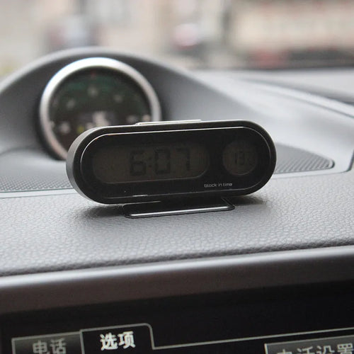 Black car dashboard electronic clock and thermometer with LED display on adjustable bracket