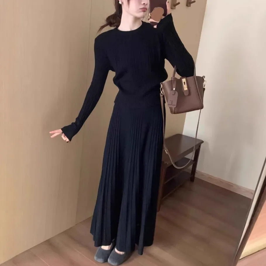 Dark grey knitted two-piece suit with 3D textured patterns, showing sweater and matching skirt