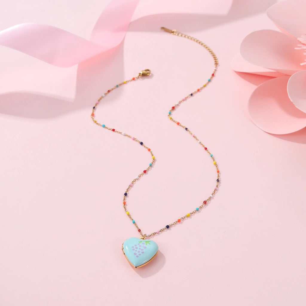 Gold-plated stainless steel necklace with heart-shaped fruit pendant on an adjustable chain.