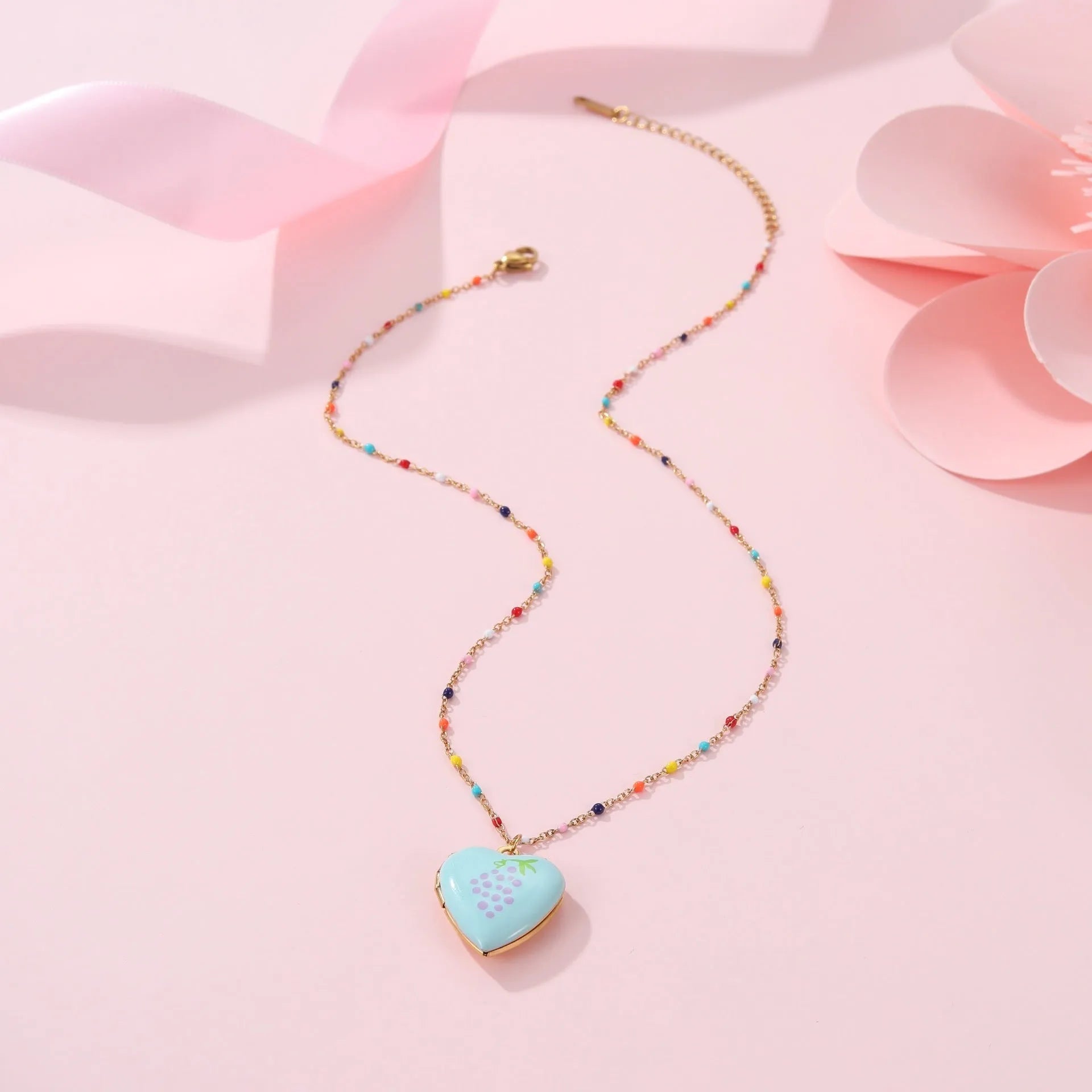 Gold-plated stainless steel necklace with heart-shaped fruit pendant on an adjustable chain.