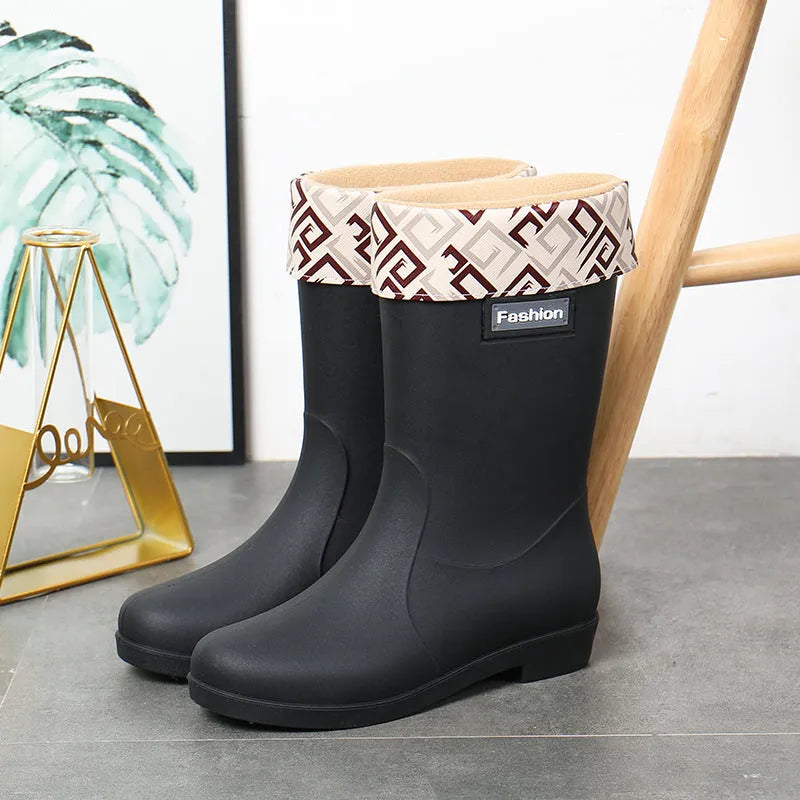 Women's mid-calf PVC rain boots in black with low heel design