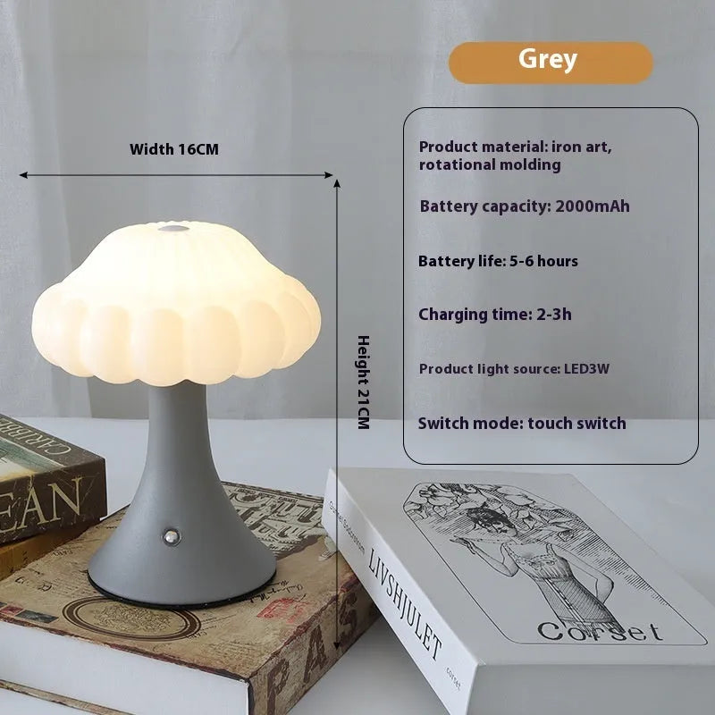 Small mushroom-shaped touch night lamp in wood grain finish on a wooden table.