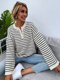 Black and white striped women's loose-fit long sleeve top with drop shoulders and button front.