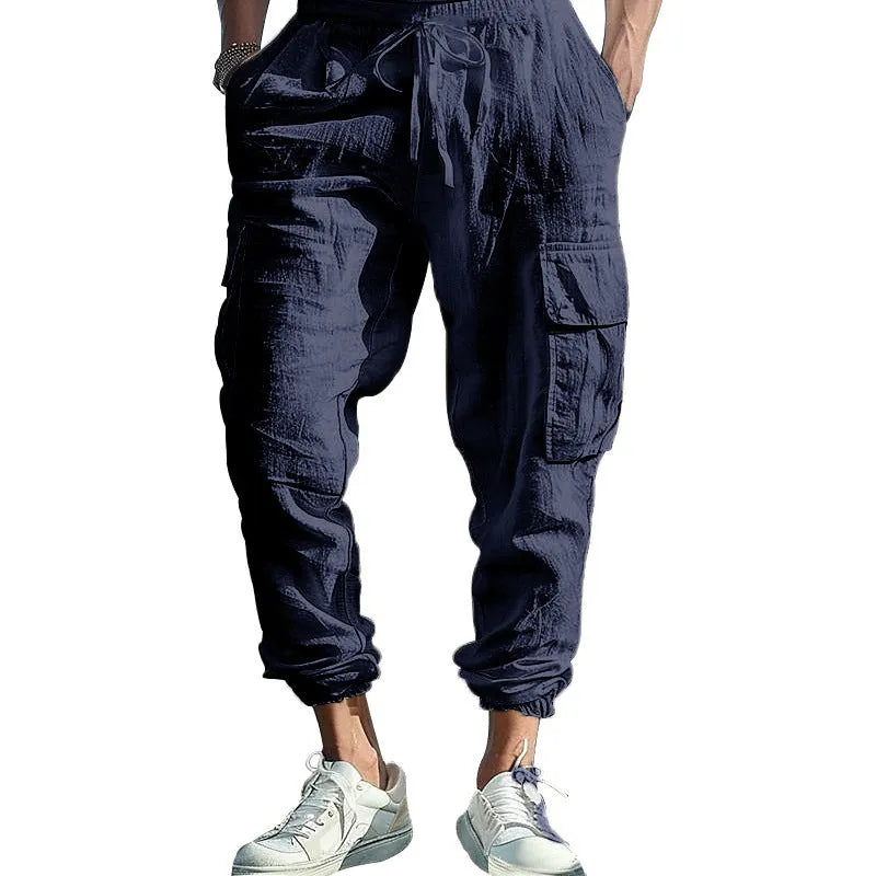 Men's loose-fit linen trousers in Army Green with ankle-tied cuffs and multiple pockets.