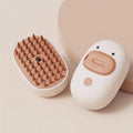 White and yellow rechargeable steam brush for grooming cats and dogs on a plain background
