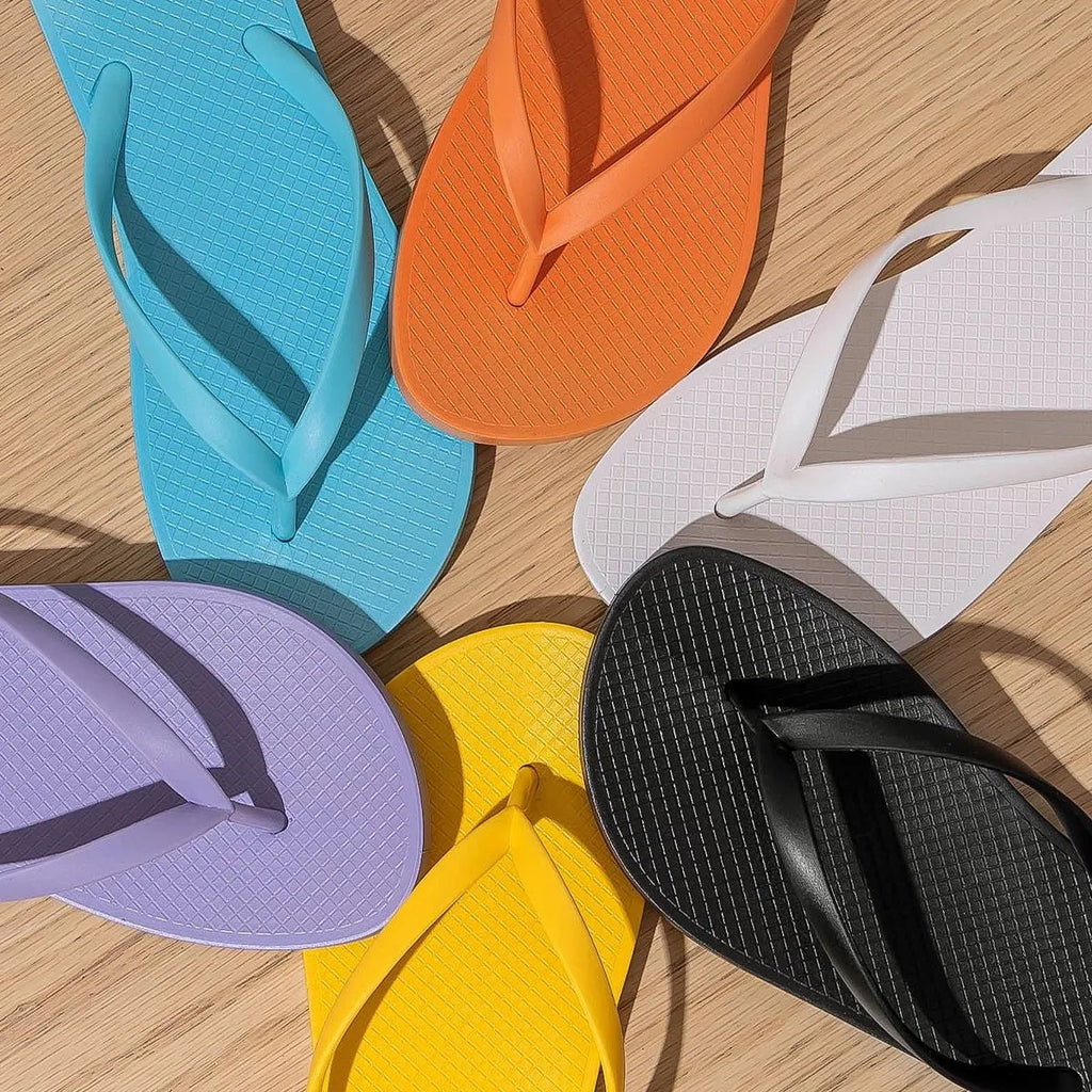 Orange foldable flat slippers with a non-slip PVC sole and hollow-out breathable design