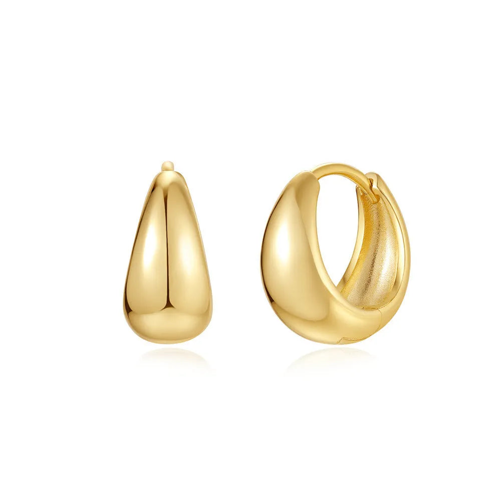 Golden brass earclip earrings with geometric shapes and round elements