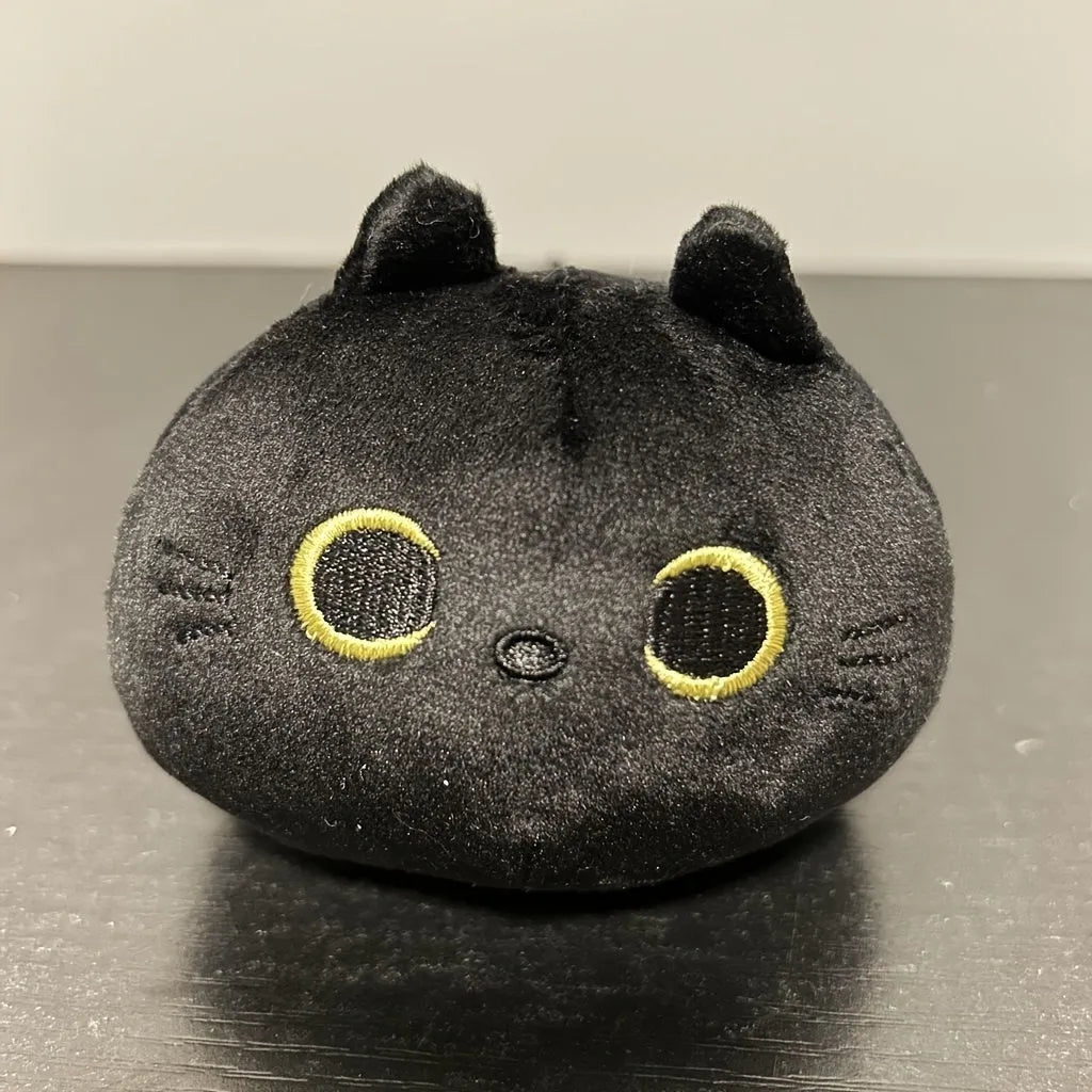 Black cat plush toy with fluffy fur and cushion design for napping