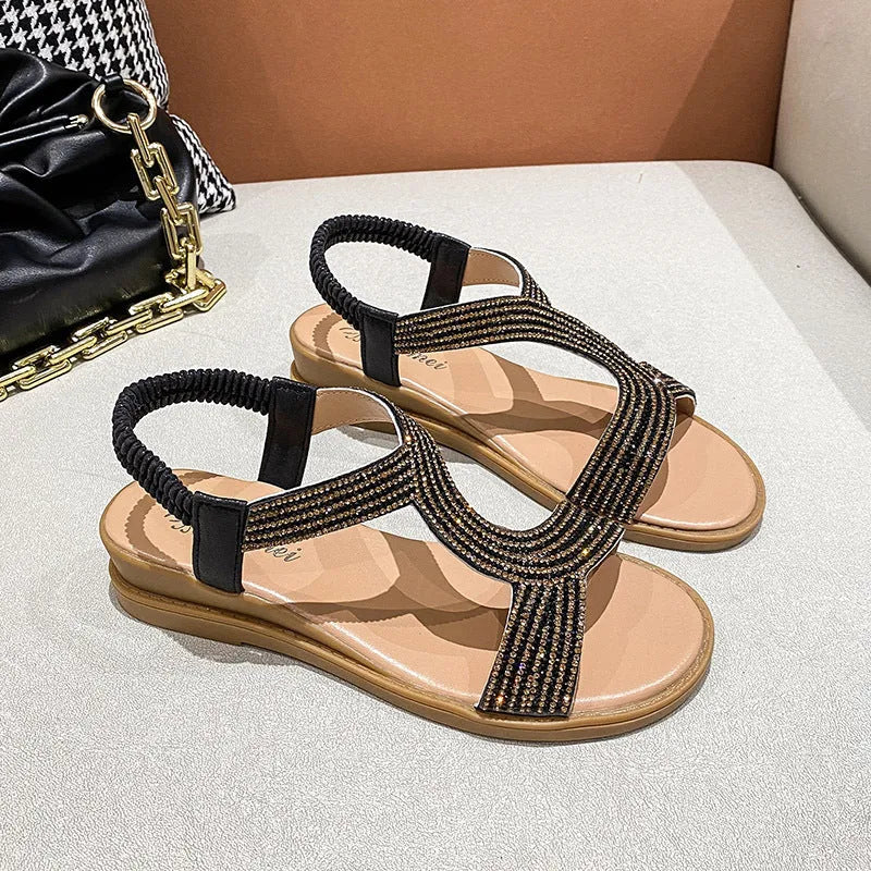Women's patent leather beach sandals with rhinestones on a round toe, shown in gold colour.