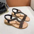 Women's patent leather beach sandals with rhinestones on a round toe, shown in gold colour.