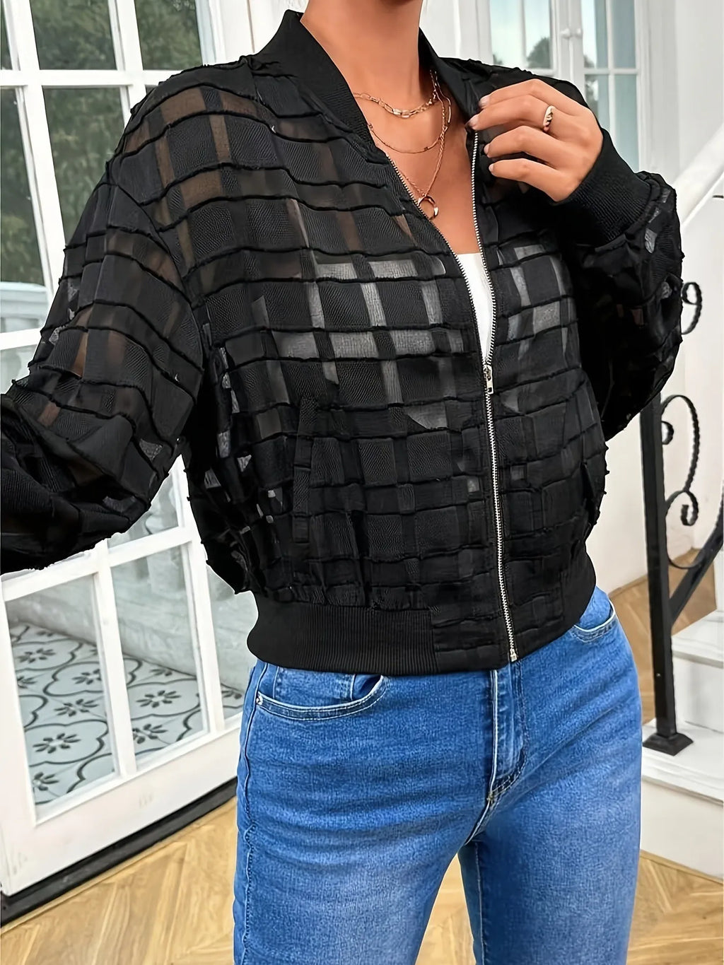 Black women's semi-transparent casual jacket with geometric pattern and front zipper.
