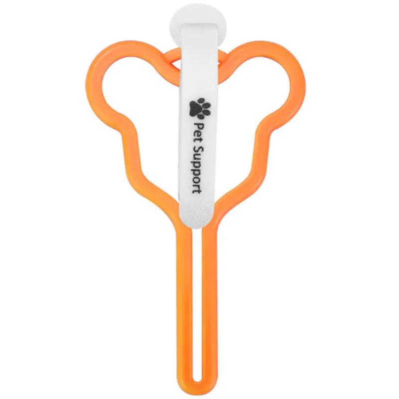 A coloured hands-free dog poop bag holder with a fixed clip and velcro strap attached to a dog leash.