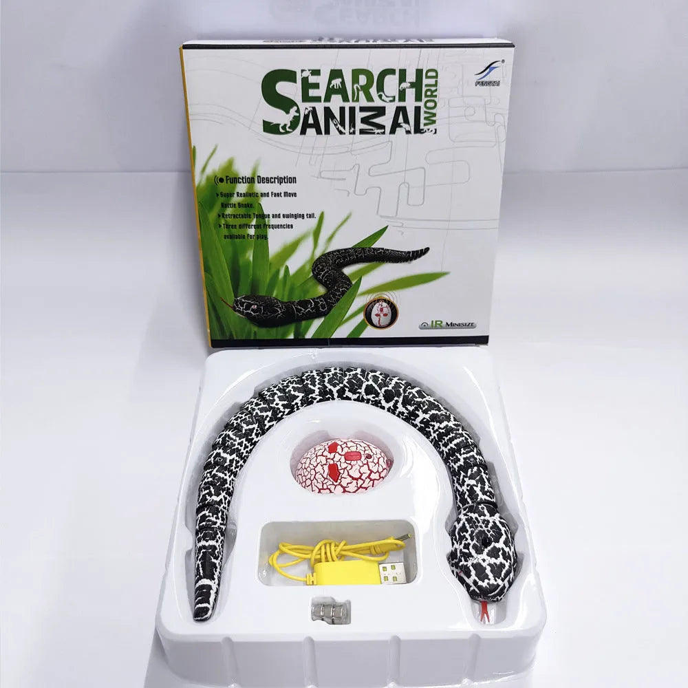 Smart sensing interactive electronic snake cat toy on a floor, showing segmented plastic body and USB charging port.