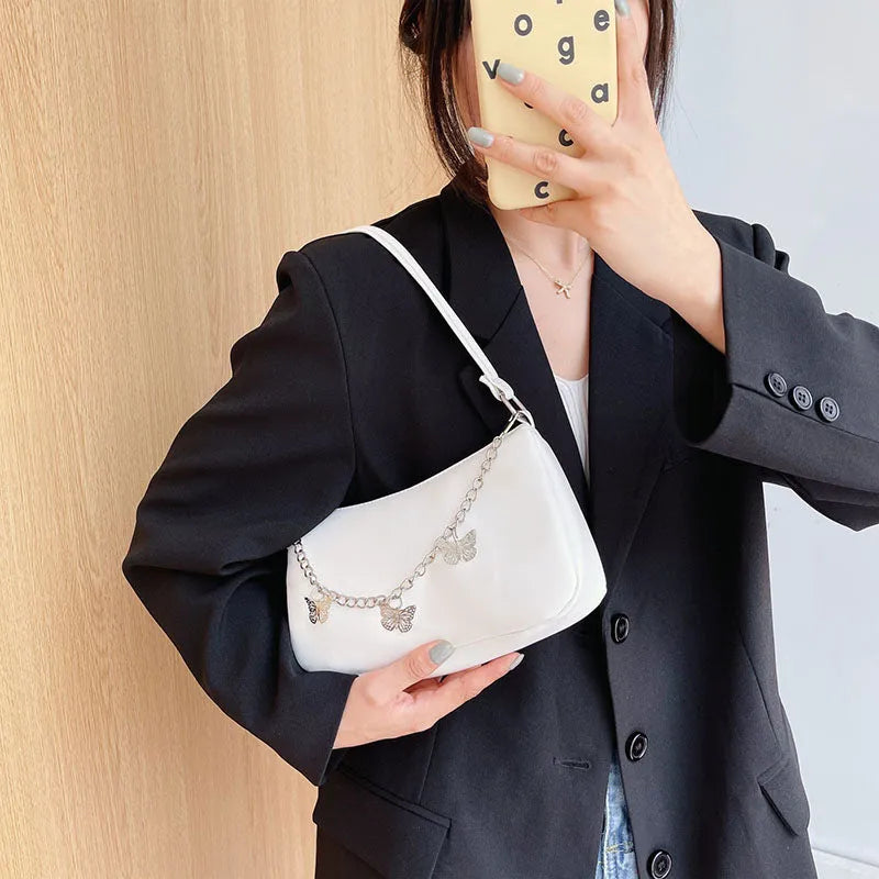 Retro women's chain-strap crossbody bag with butterfly charm in light blue PU leather