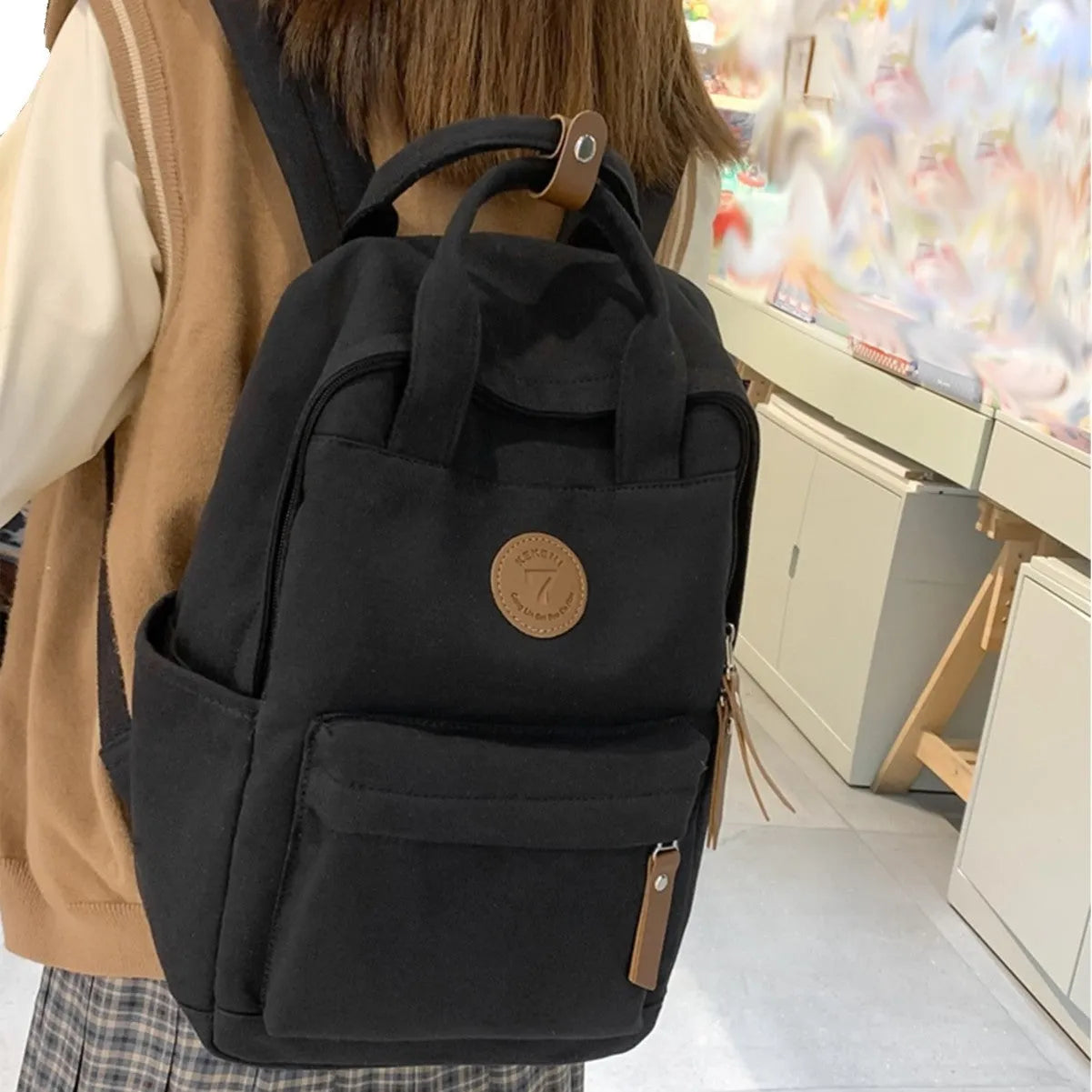 Black Oxford cloth backpack with curved shoulder straps in urban simplicity style